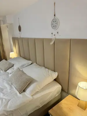 a bed with two pillows on it in a room at Apartamenty Oracka Przystań Solna 1 in Bochnia