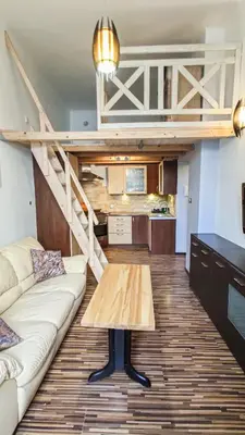 a living room with a couch and a loft at Sweet Home Apartament in Kraków