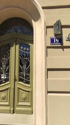 a door to a building with a sign on it at Sweet Home Apartament in Kraków