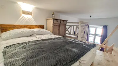 a bedroom with a large bed with a wooden headboard at Sweet Home Apartament in Kraków