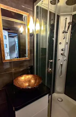 a bathroom with a sink and a shower at Sweet Home Apartament in Kraków