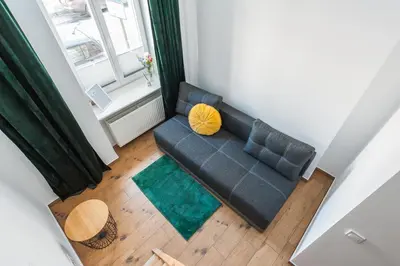 an overhead view of a couch in a living room at Apartamenty przy Kładce- Kazimierz Old Town in Kraków