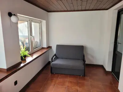 a chair in a room with a window at Atrium Jerzmanowice in Jerzmanowice