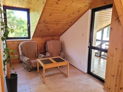 a living room with two chairs and a table at Atrium Jerzmanowice in Jerzmanowice