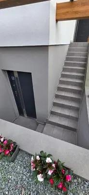 a staircase with flowers in front of a building at Apartament Zabawa in Wieliczka