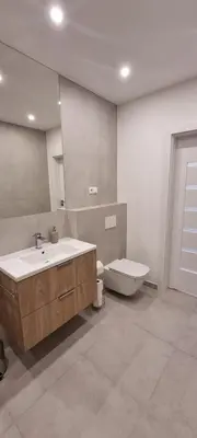 a bathroom with a sink and a tub and a toilet at Apartament Zabawa in Wieliczka