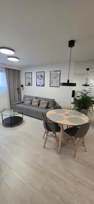 a living room with a couch and a table at Apartament Zabawa in Wieliczka