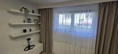 a room with a window and a vase on a shelf at Apartament Zabawa in Wieliczka