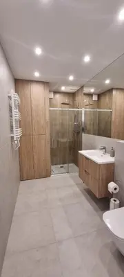 a bathroom with a tub and a sink and a shower at Apartament Zabawa in Wieliczka