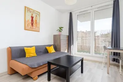 a living room with a couch and a table at Borkowska Corner in Kraków