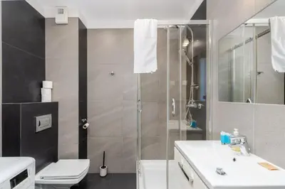 a bathroom with a shower and a toilet and a sink at Borkowska Corner in Kraków