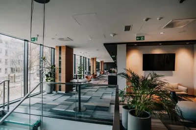 a lobby with potted plants in a building at Q Hotel Plus Kraków in Kraków