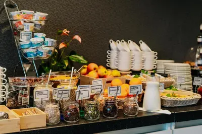 a buffet with fruit and other food on a table at Q Hotel Kraków in Kraków