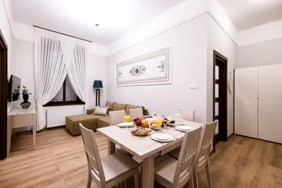 a dining room and living room with a table and chairs at Family AC apartment Old Town Main Railway Station in Kraków