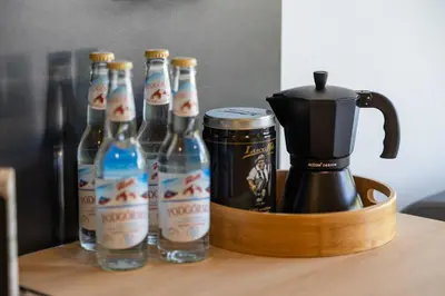 a group of bottles of beer on a table with a blender at Piotrowiczówka Osada w Szczyrzycu in Szczyrzyc