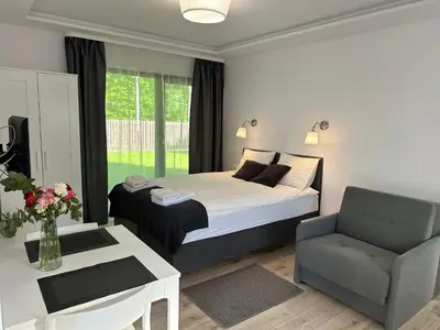 a living room with a couch and a table at Villa Kryspinów K&J in Kryspinów
