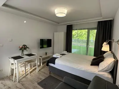 a small room with a bed and a chair at Villa Kryspinów K&J in Kryspinów