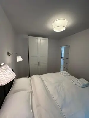 a bedroom with a large white bed with a lamp at Villa Kryspinów K&J in Kryspinów