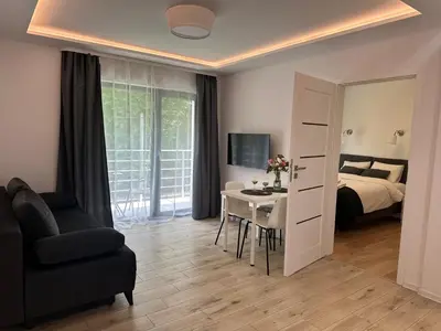 a bedroom with a bed and a desk and a tv at Villa Kryspinów K&J in Kryspinów