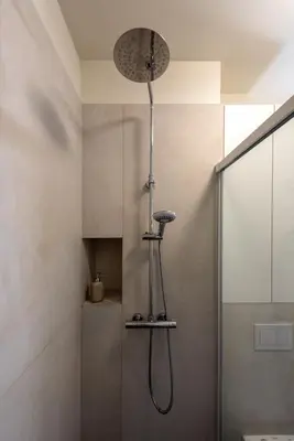a shower with a shower head in a bathroom at Wawel View Stylish Apartment in Kraków
