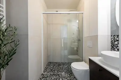 a bathroom with a shower and a toilet and a sink at Wawel View Stylish Apartment in Kraków