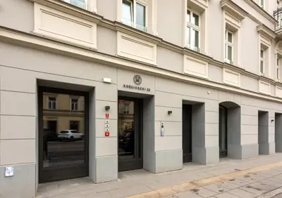 a building with doors and windows on a street at Wawel View Stylish Apartment in Kraków