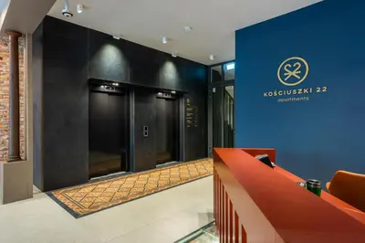 a lobby with two elevators in a building at Wawel View Stylish Apartment in Kraków