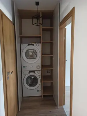 a laundry room with a washer and dryer at Centrum Konferencyjno-Noclegowe in Iwkowa