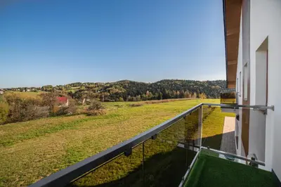 a balcony with a view of a field at Centrum Konferencyjno-Noclegowe in Iwkowa
