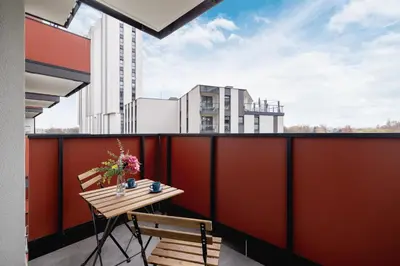 a balcony with a table and chairs on a building at Cozy Apartments Łaszkiewicza with Parking by Noclegi Renters in Kraków