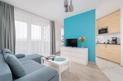 a living room with a couch and a table at Cozy Apartments Łaszkiewicza with Parking by Noclegi Renters in Kraków