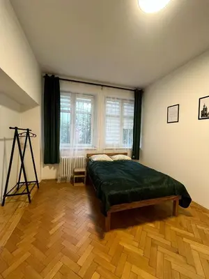 a bedroom with a bed in a room with a window at Krowoderska Lovely Room in Kraków
