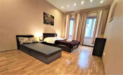 a living room with a bed and a couch at Abak Krakow Apartment in Kraków