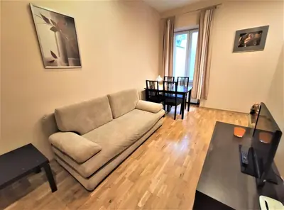 a living room with a couch and a table at Abak Krakow Apartment in Kraków