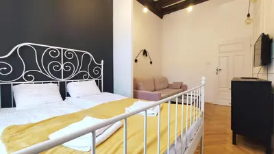 a bedroom with a bed and a couch at Floriańska 10 C-D by Homeprime in Kraków