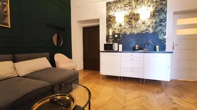 a living room with a couch and a counter at Floriańska 10 C-D by Homeprime in Kraków