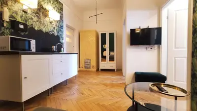 a kitchen with a glass table in a room at Floriańska 10 C-D by Homeprime in Kraków