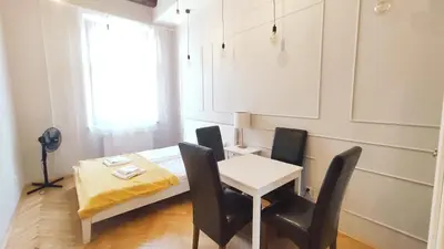 a room with a table and chairs and a bed at Floriańska 10 C-D by Homeprime in Kraków
