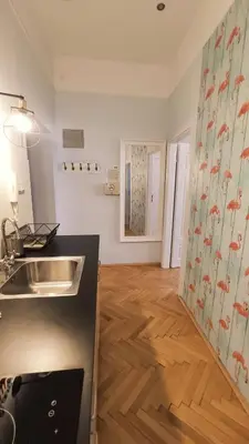 a kitchen with a sink and a wooden floor at Floriańska 10 C-D by Homeprime in Kraków