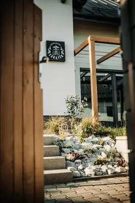 a door entrance to a building with a sign on it at Jurajski Zakątek in Skała