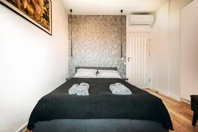 a bedroom with a bed with two pairs of shoes on it at Jurajski Zakątek in Skała