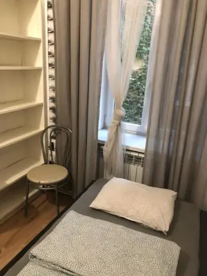 a small room with a chair and a window at Mini in Kraków