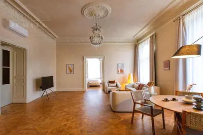 a living room with a couch and a table at Fragola Apartments Le Jardin - classy, spacious Old Town apartments in Kraków
