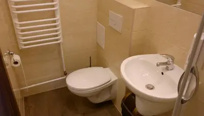 a small bathroom with a toilet and a sink at Ośrodek SCSK Optima in Kraków