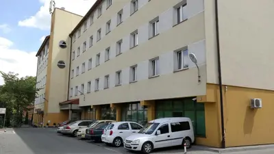 a row of cars parked in front of a building at Ośrodek SCSK Optima in Kraków