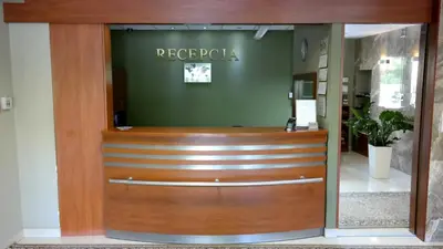a wooden front door of a reporia office at Ośrodek SCSK Optima in Kraków