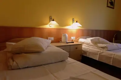 a hotel room with two beds and two lights at Ośrodek SCSK Optima in Kraków