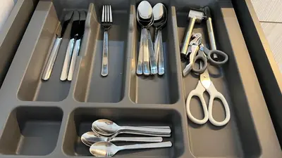 a tray with silver utensils in a sink at MintKrak in Kraków