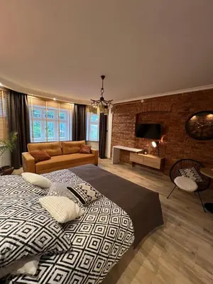 a bedroom with a large bed and a living room at Apartamenty K9 in Kalwaria Zebrzydowska