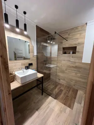 a bathroom with a sink and a shower at Apartamenty K9 in Kalwaria Zebrzydowska